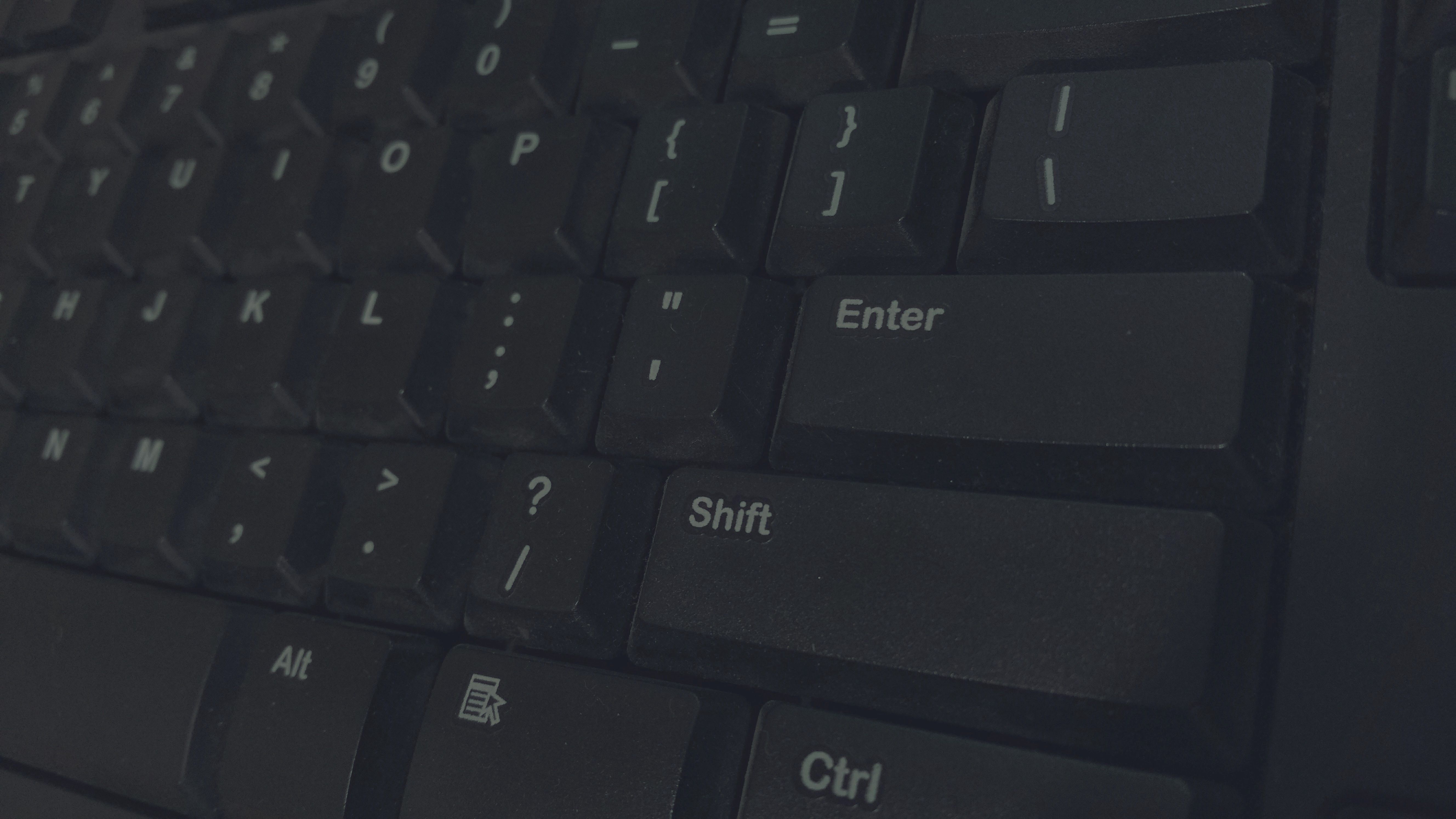 Detailed shot of black computer keyboard showcasing various keys for technology concepts.