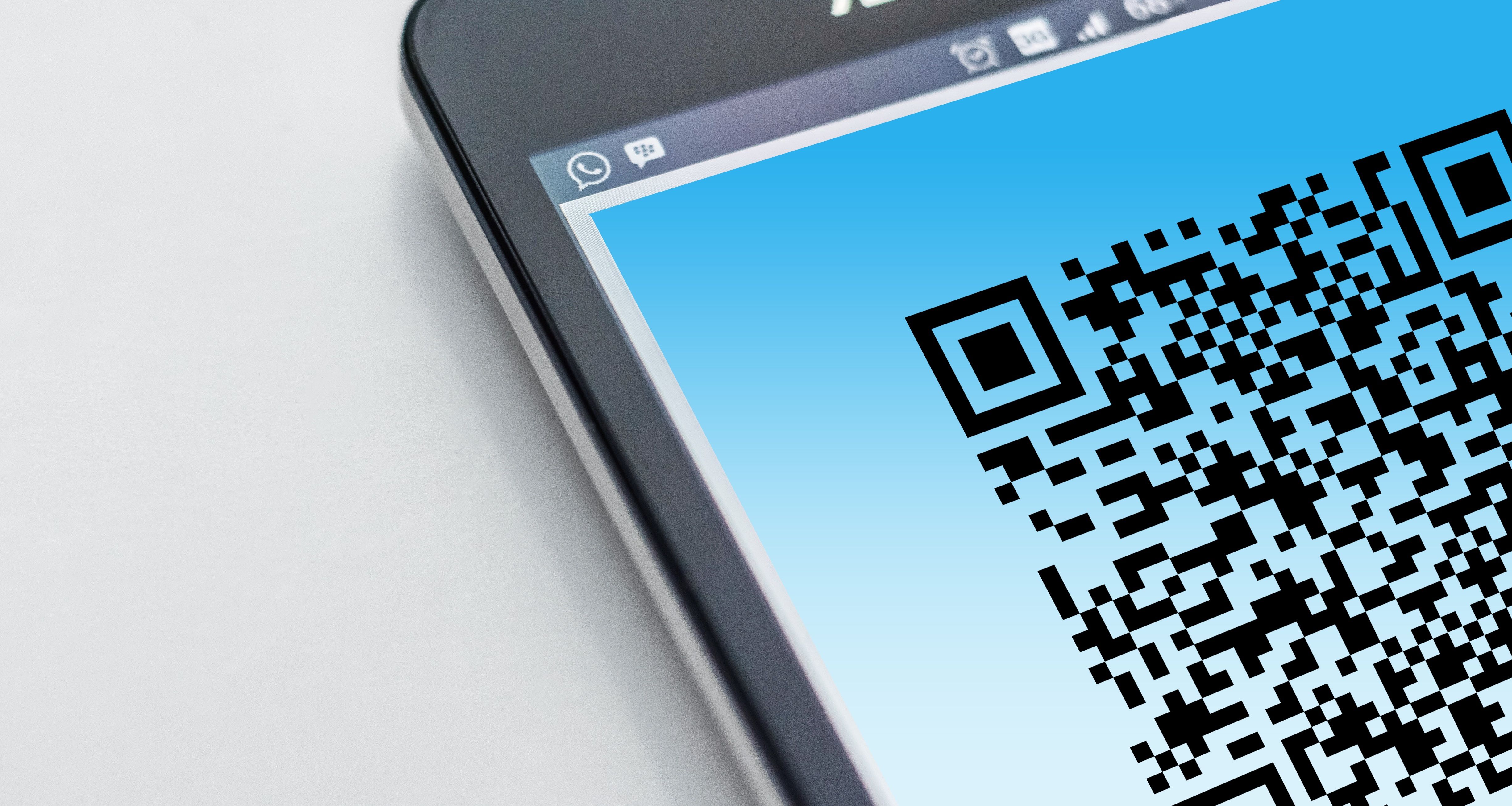 High-resolution close-up of a smartphone displaying a QR code on its screen.