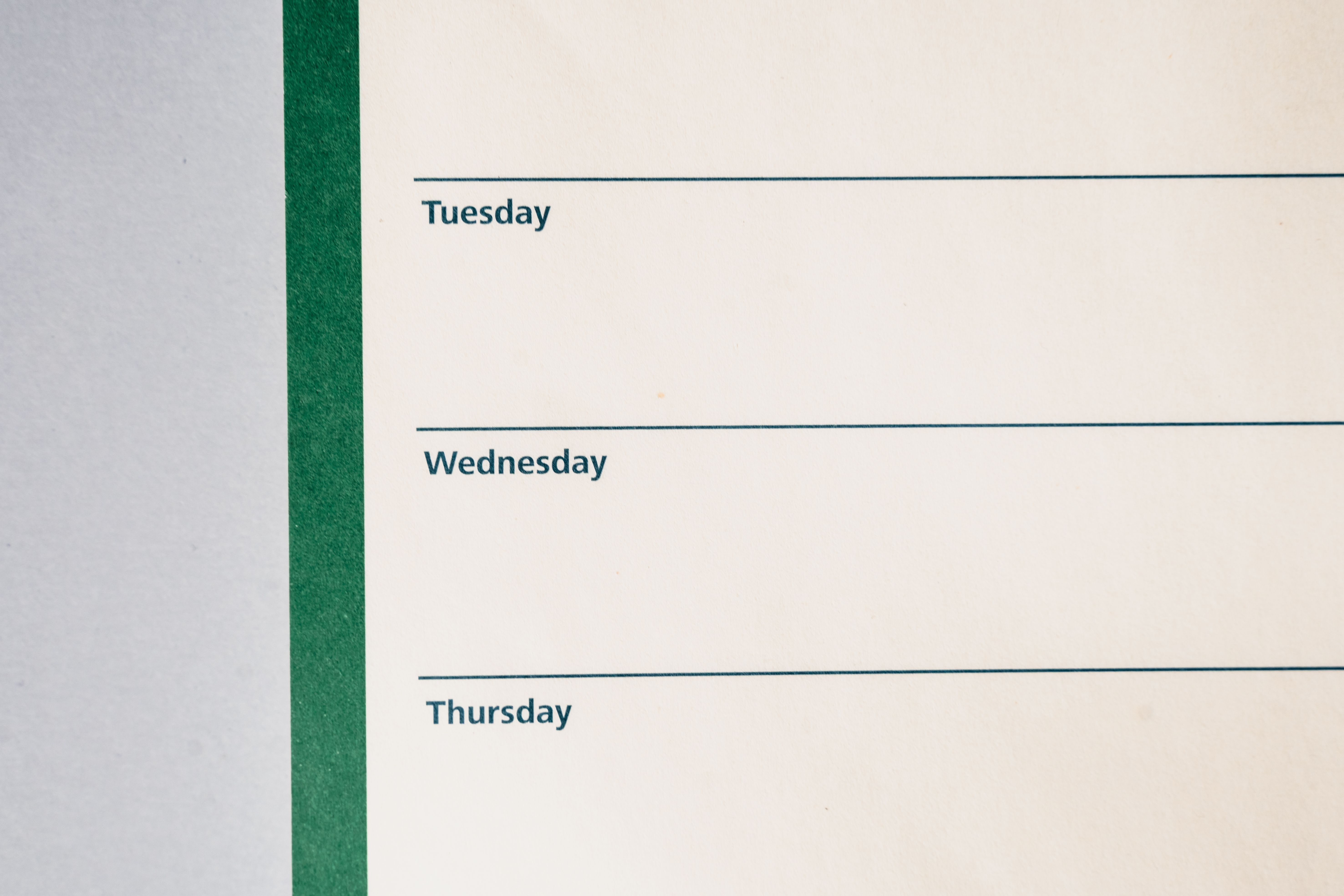 Close-up view of a minimalist weekly planner featuring days of the week.